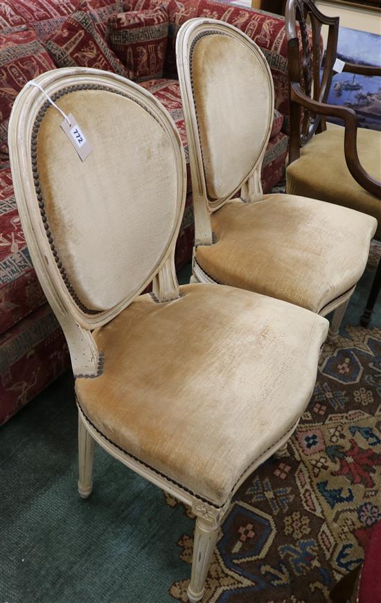 A pair of French painted salon chairs